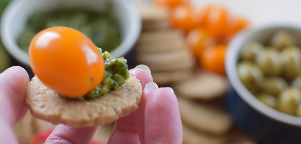 Love Local Cheddar paired with pesto and a cherry tomato.